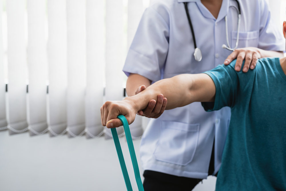 Close-up of a physiotherapist treating a patient at a clinic.
