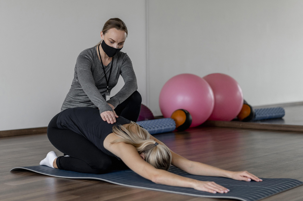 young-woman-exercising-gym-helped-by-coach